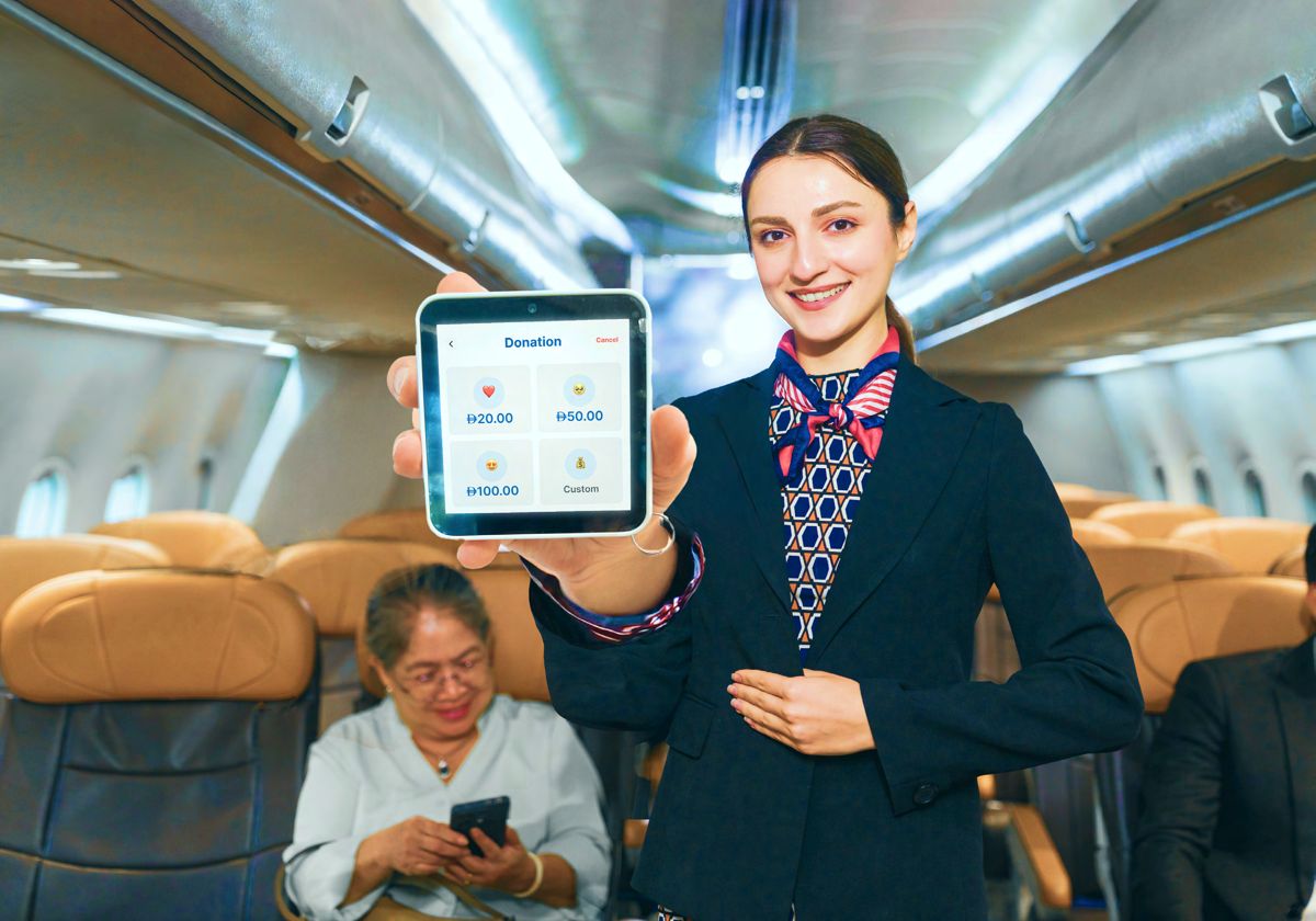 Crew member showing donation presets on an AFS Lite Mini POS