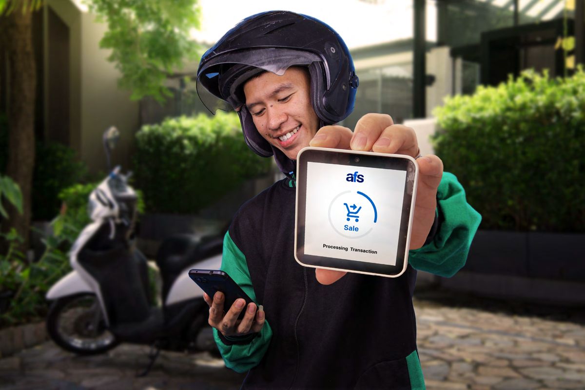Delivery driver holding an AFS Lite Mini POS processing a sale