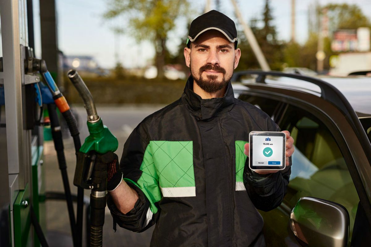 Garage attendant holding an AFS Lite Mini POS confirming a payment